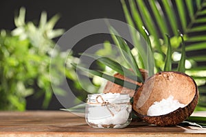 Composition with natural organic coconut oil on wooden table photo