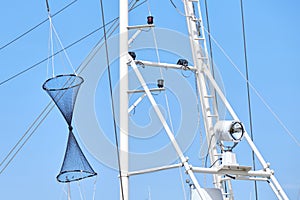 Composition is navy consisting of a lamp, rope, masts and fishing net against a blue sky. Background consept