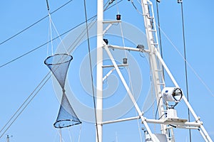 Composition is navy consisting of a lamp, rope, masts and fishing net against a blue sky. Background consept