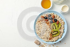Composition oatmeal with fruits on white background