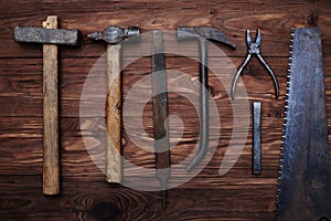 A composition of old carpenterâ€™s tools on wooden background