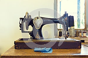 Composition with an old sewing machine with threads