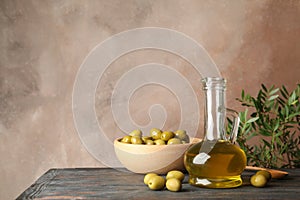 Composition with olive oil and olives on table, close up