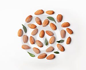 Composition with organic almond nuts on white background