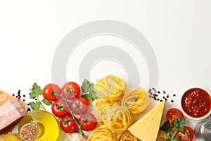 Composition pasta and ingredients for cooking on white background, top view