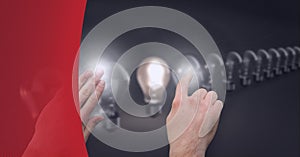 Composition of person touching lit light bulb with row of light bulbs on grey background
