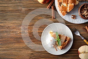 Composition with piece of delicious apple pie and ice cream on wooden background
