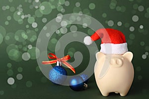 Composition with piggy bank and Christmas decor on color background.