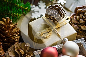 Composition from pile of Christmas and New Year gift boxes in craft paper, colorful balls, pine cones, fresh fir tree branches, wo