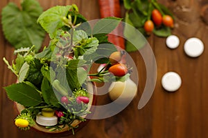 Composition with pills and herbs on wooden background