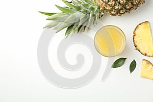 Composition with pineapple, slices and glass of juice on white background