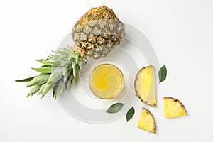 Composition with pineapple, slices and glass of juice on white background