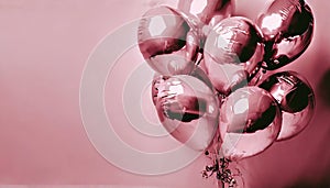 Composition of pink foil balloons with helium on background with copy space