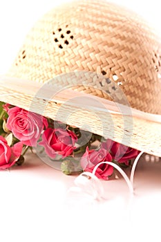 Composition with pink miniature roses and hat