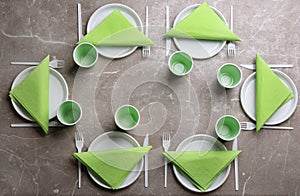 Composition with plastic dishware on grey background