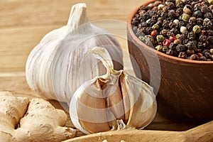 Composition of powder spices on spoon and different sorts of spicies on wooden table background, selective focus