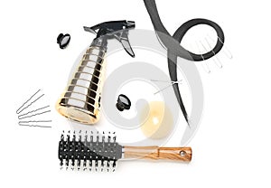 Composition with professional hairdresser\'s supplies and strand on white background