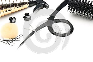 Composition with professional hairdresser\'s supplies and strand on white background