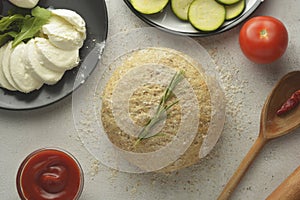 Composition with raw dought and fresh ingredients for pizza isolated on white background. Copy space. Flat lay food ingredients