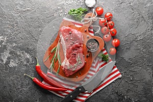 Composition with raw meat, vegetables and spices on grunge background