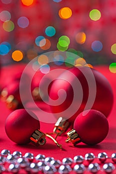 Composition of red christmas balls on red table