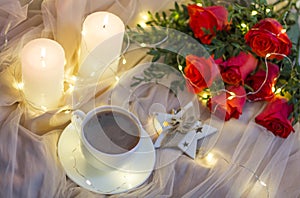 Composition: red roses with boxwood, garlands, candles, star and cup coffee