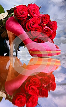 Composition with red roses and pink female shoe