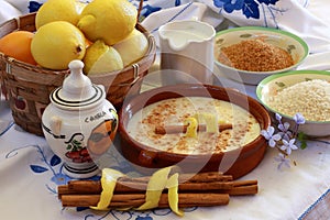 Composition with rice pudding ingredients on embroidered tablecloth