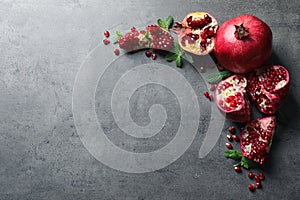 Composition with ripe pomegranates and space for text on grey background