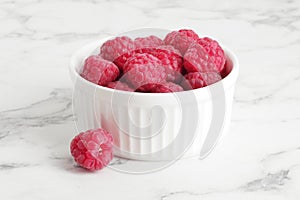 Composition of ripe raspberries in a bowl