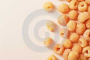 Composition of ripe yellow raspberries on a colored