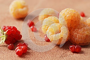 Composition of ripe yellow raspberries on a marble