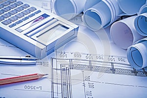 Composition rolled blueprints calculator pencil