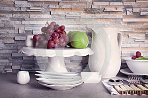 Composition with rustic dinnerware and fruits