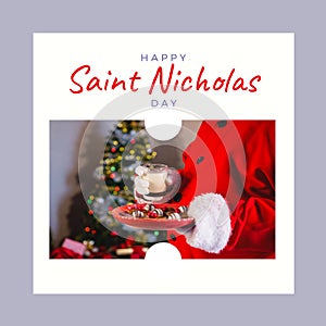 Composition of saint nicholas day text over santa claus holding plate with cookies and milk