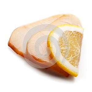 Composition with salmon, lemon slice and salad leaf
