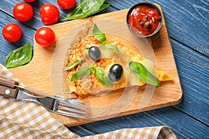 Composition with slice of tasty pizza on wooden table