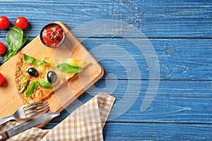 Composition with slice of tasty pizza on wooden table