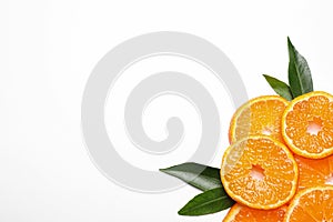 Composition with slices of fresh ripe tangerines and leaves on white background. Citrus fruit