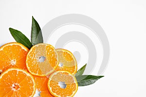 Composition with slices of fresh ripe tangerines and leaves on white background. Citrus fruit