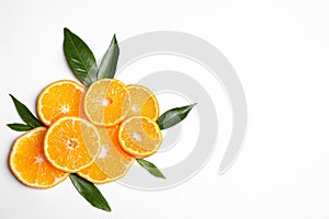 Composition with slices of fresh ripe tangerines and leaves on white background. Citrus fruit