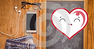 Composition of smiling heart with glasses, jeans, smartphone and earphones on wooden surface