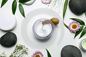 Composition with snail and cosmetic products on white background, top view