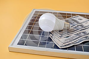 Composition with solar panel, led lamp, money