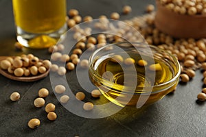 Composition with soybean oil on grey table, closeup