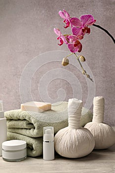 Composition with spa products and beautiful flower on grey wooden table