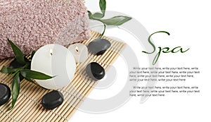 Composition with spa stones and burning candles on white background, closeup. Banner design with space for text