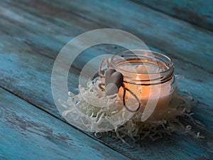 Composition of spa treatment candle on wooden background. Copy space