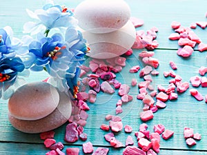 composition still life with blue flowers, massage stones, Spa concept, the substrate, a space on a wooden blue background