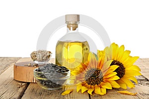 Composition with sunflower oil on wooden table against white background